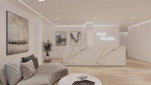 A modern hotel reception area with a marble reception desk, a sofa, and a coffee table. - Sololaki Hills (Tbilisi)