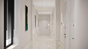 A modern hallway with white walls, a marble floor, and doors on the right. - Sololaki Hills (Tbilisi)
