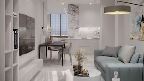 A modern living room with a grey sofa, a dining table, and a coffee table. - Sololaki Hills (Tbilisi)
