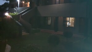 A two-story building with a staircase leading to the upper floor. - St Michelle Guest Lodge (Alberton)