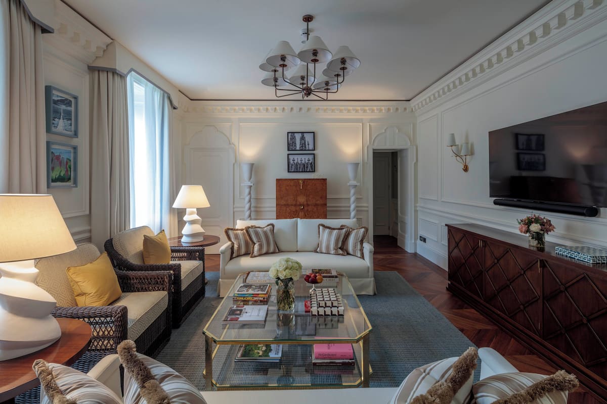 A spacious living room with a sofa, coffee table, and television.