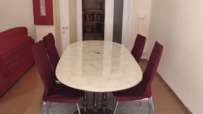 Zona pranzo con un tavolo rotondo e sei sedie.