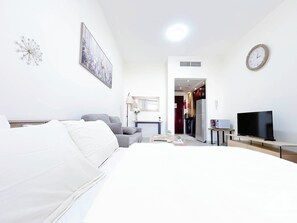Tabla de planchar con plancha y ropa de cama