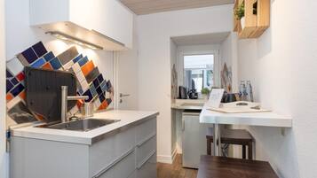 Fridge, coffee/tea maker, toaster, cookware/dishes/utensils