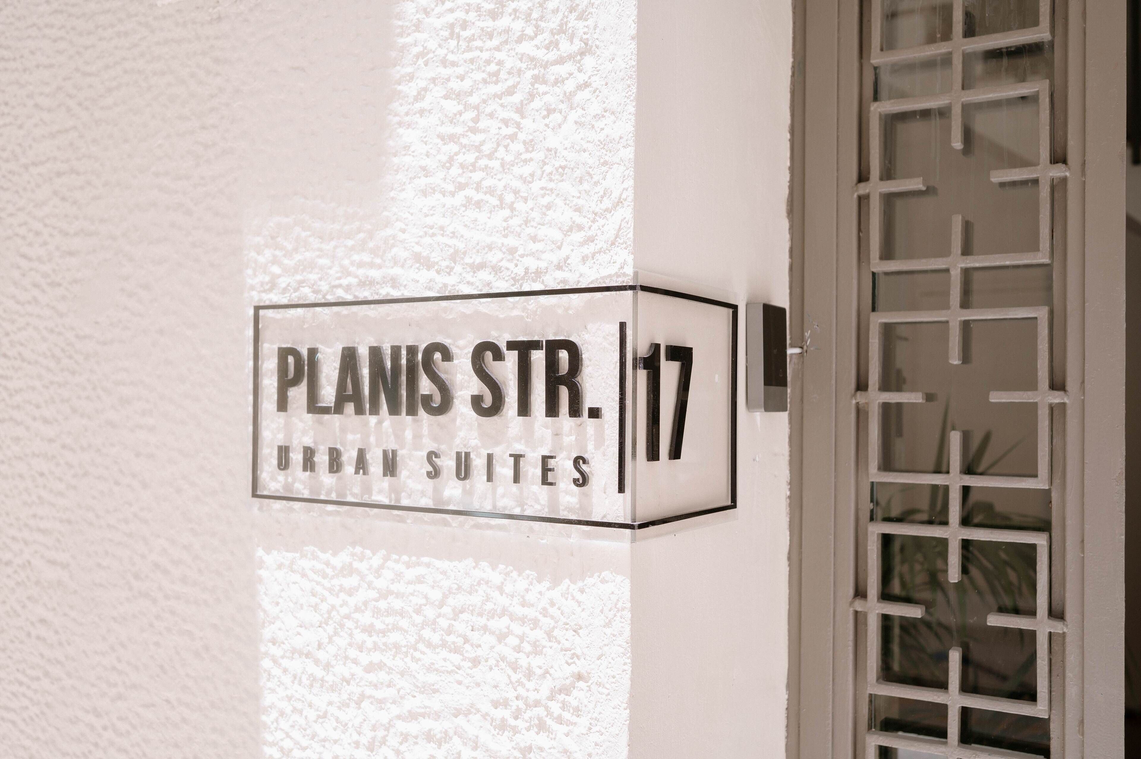 Segnaletica per 'Planis Str. 17 Urban Suites' su una facciata.