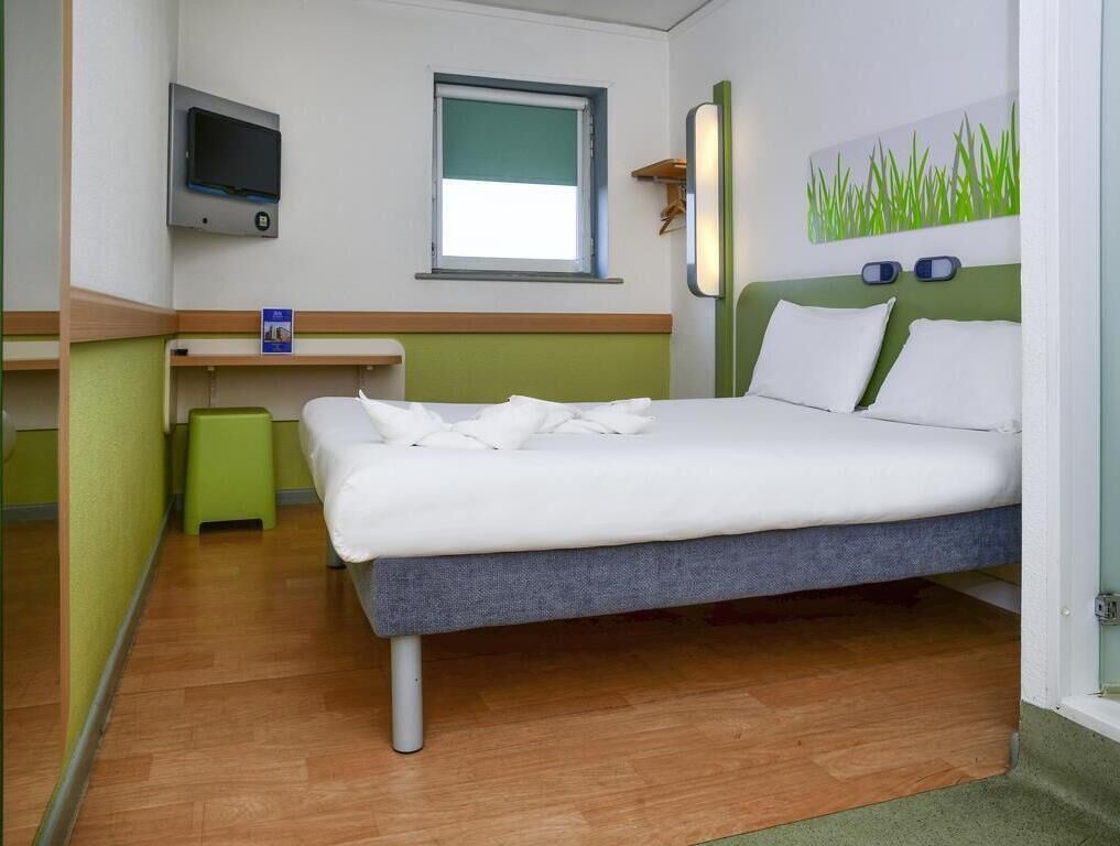 Hypo-allergenic bedding, desk, laptop workspace, blackout curtains