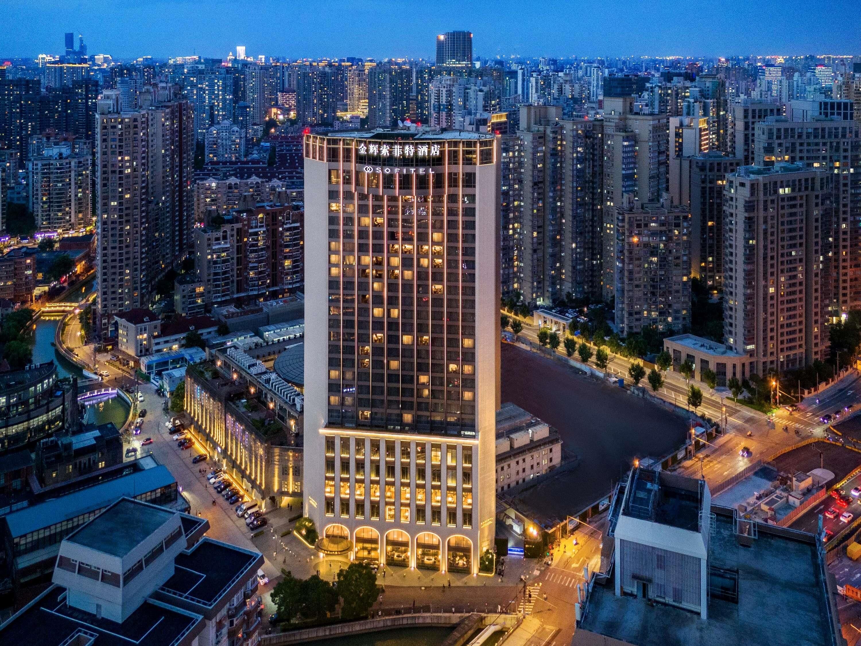 A high-rise building with a modern design, featuring a prominent entrance and a large glass facade.