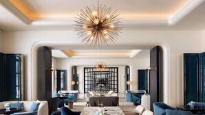 A spacious hotel lobby with a marble reception desk, modern chairs, and a unique chandelier. - Sofitel Shanghai North Bund (Shanghai)