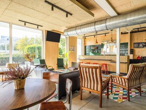 A modern interior with a wooden ceiling, a bar area, and seating arrangements. - greet Brussels Airport Zaventem (Zaventem)