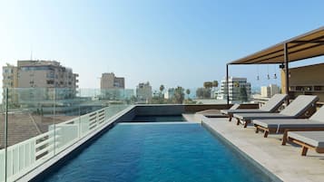 Outdoor pool, open 7:00 AM to 9:00 PM, pool loungers