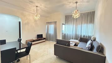 Standard Double Room | Living area | Flat-screen TV