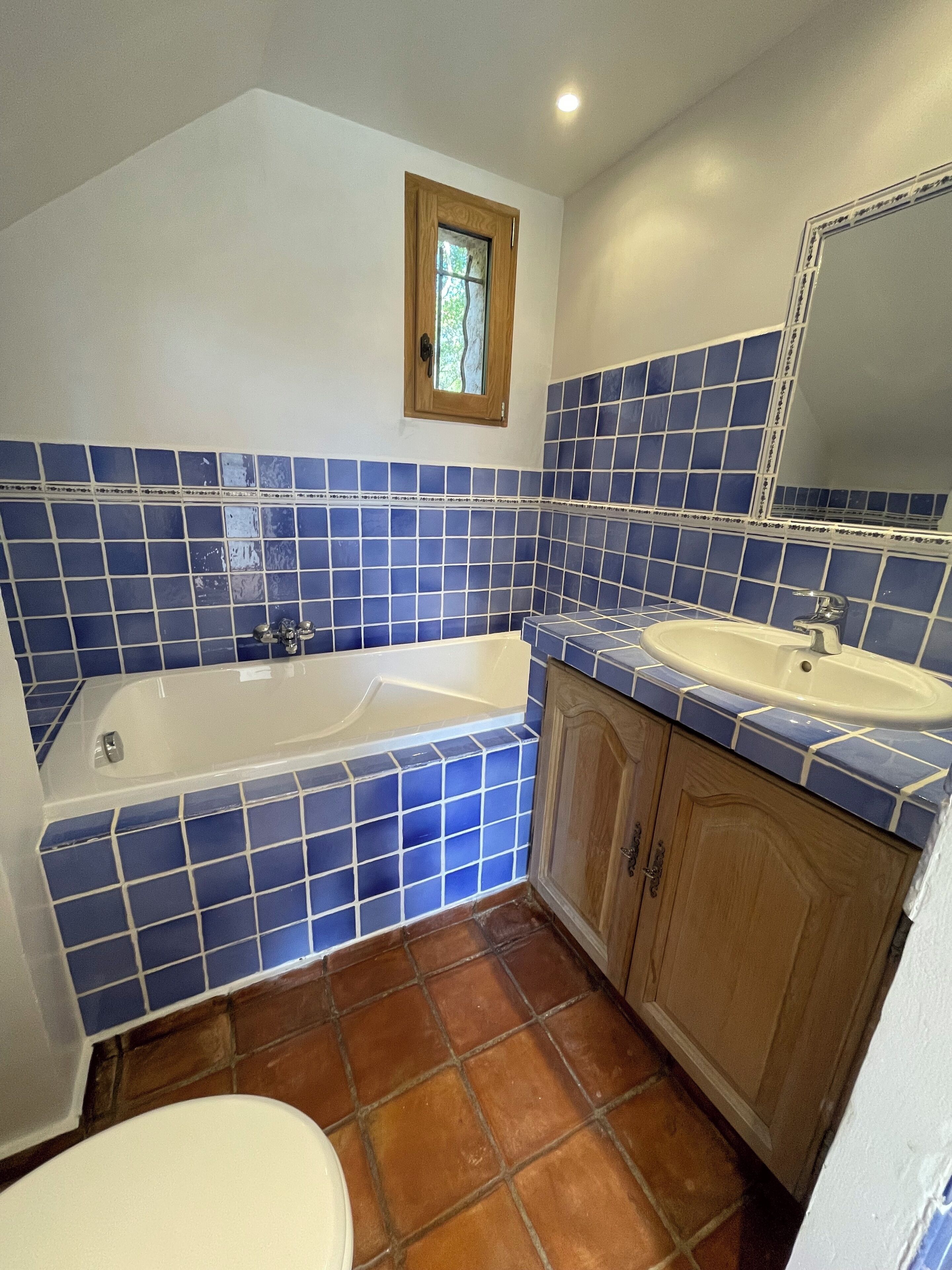 A bathroom with a bathtub, a sink, and a toilet.