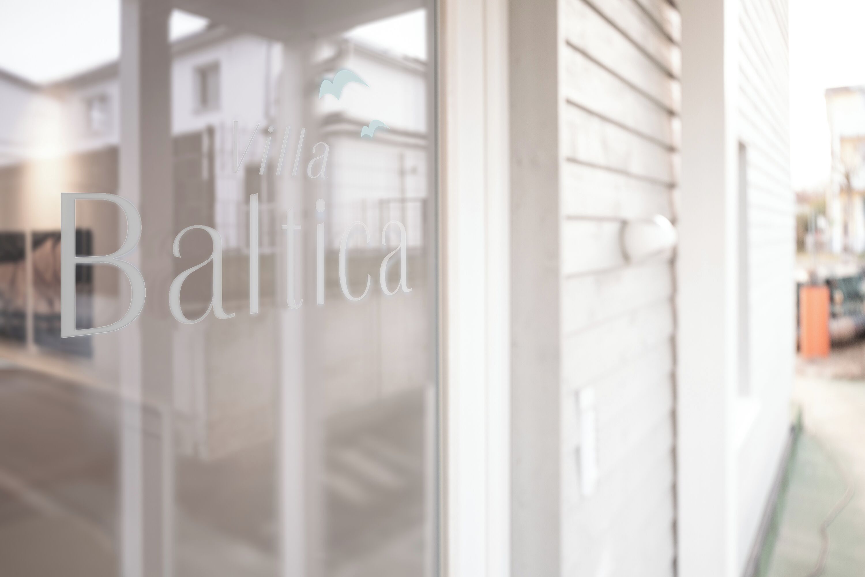 A glass door with the text "Balthia" visible.
