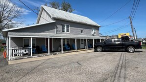 A two-story building with a porch, a black pickup truck parked in front, and a sign indicating it is a restaurant. - Fishermen’s Denn-Marblehead and Port Clinton  vacation area (Port Clinton)