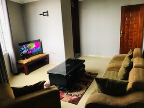 Family Condo, City View | Living area | Flat-screen TV - SIMPLE GUEST HOUSE (Addis Ababa)