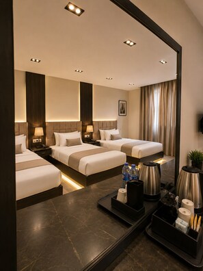 A hotel room with three beds, a large mirror, a coffee station, and a view of the city. - Crowne pyramids palace (Giza)