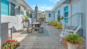 A courtyard with outdoor seating, air conditioning units, and a staircase. - Sunlit Studio Escape: Hollywood Haven, sleeps 4! (Hollywood)