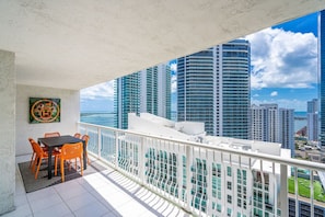 Enjoy the city view from this balcony with a table and chairs, perfect for taking in the sights.