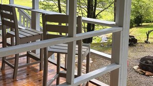 A wooden deck with a railing, a table, and chairs. - Godin's Get A Way,  Creekside cabin, Relax in Murphy, NC.  Close to everywhere! (Murphy)
