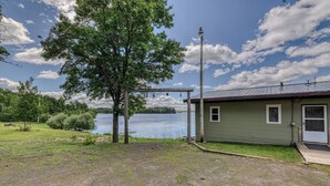 Un chalet au bord du lac, doté d’une véranda, d’un quai et offrant une vue sur le lac.