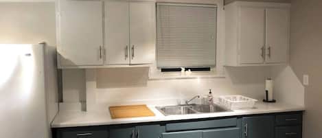 Fridge, microwave, coffee/tea maker, cookware/dishes/utensils