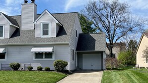 A two-story house with a garage, a chimney, and a well-maintained lawn. - Westerville Comfort & Convenience (Westerville)