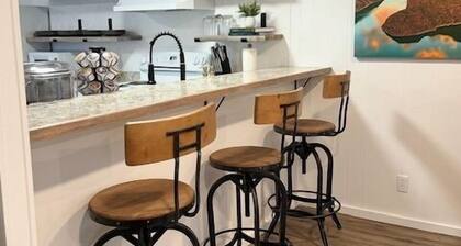 Completely Renovated home comfortably accommodates your stay with a queen bed in the primary bedroom, a twin bed with a pull-out trundle in the second bedroom, and a sleeper sofa in the living room for additional guests.