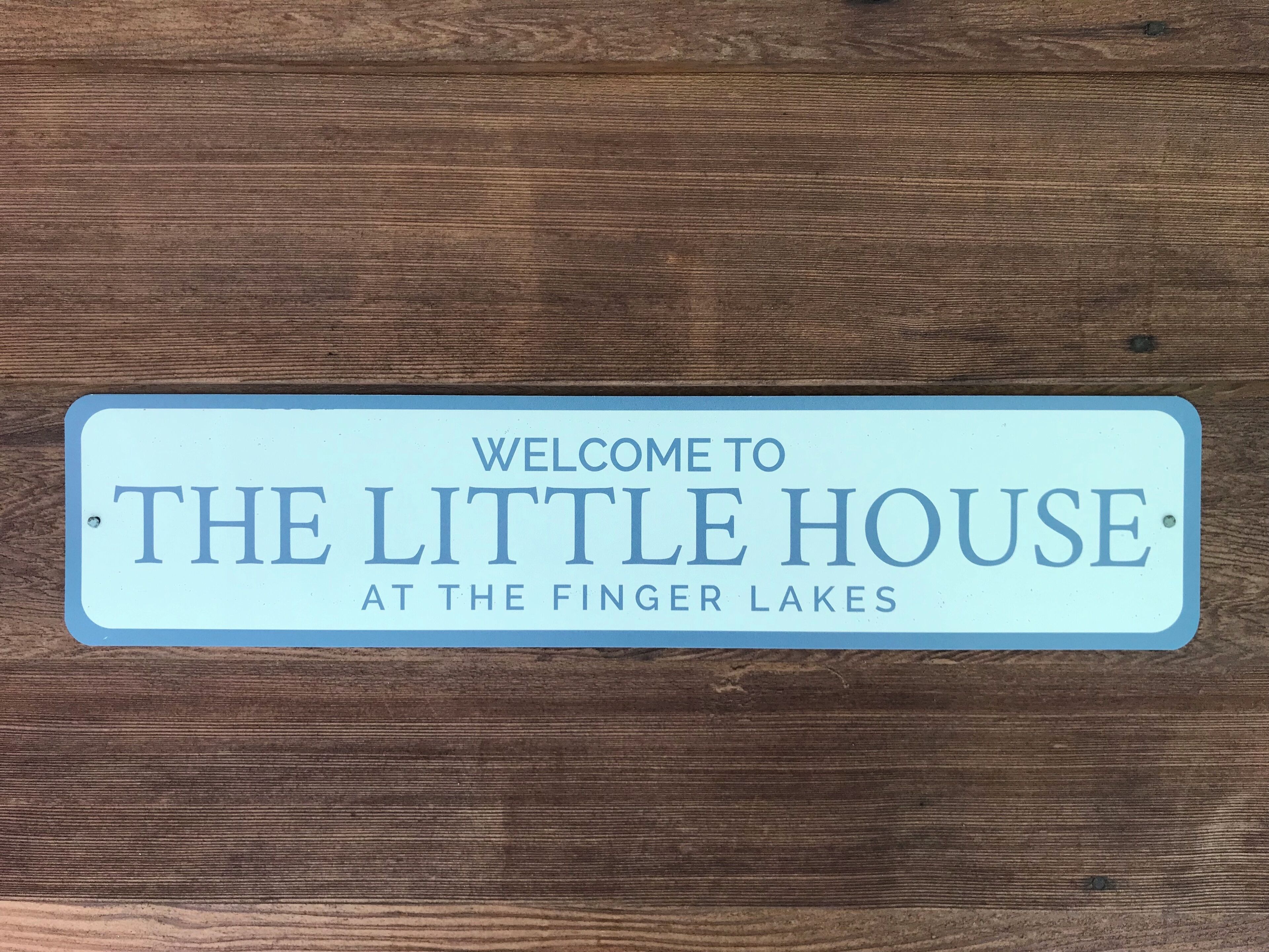 A welcome sign for The Little House at the Finger Lakes.