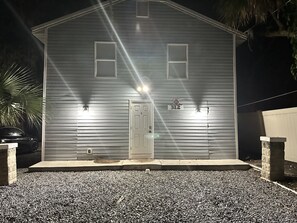 A two-story building with a metal exterior, a front door, and two windows on the second floor. - Renovated 2BR w/ Fire Pit, King Bed & Laundry · 8 Min to Speedway & Beach (Daytona Beach)