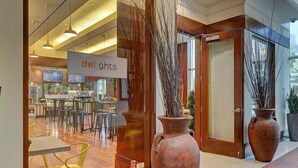 A restaurant with a modern interior, large vases, and a sign reading "delights". - Renovated Luxury Studio Suite in Tower 3, New Luxury Suite Tower 3 (Paradise)