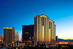 A high-rise hotel with a prominent central tower, surrounded by other buildings. - Renovated Luxury Studio Suite in Tower 3, New Luxury Suite Tower 3 (Paradise)
