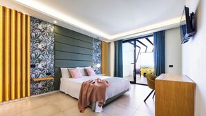 A modern hotel room with a bed, a desk, and a view of the outdoors. - Modern Villa for Groups with Pool, Spa & Sea View | 13 Guests | Sicily (Partinico)