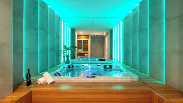 A modern spa room with a hot tub, wooden flooring, and ambient lighting. - Modern Villa for Groups with Pool, Spa & Sea View | 13 Guests | Sicily (Partinico)