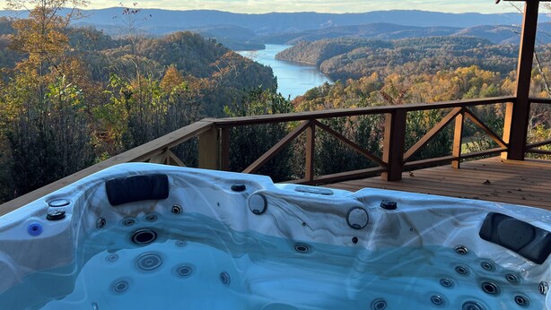 A hot tub on a wooden deck overlooking a scenic view of a lake and mountains. - Stunning, Mtn-Top, Lakeview Cabin on Private 8 acres (Butler)