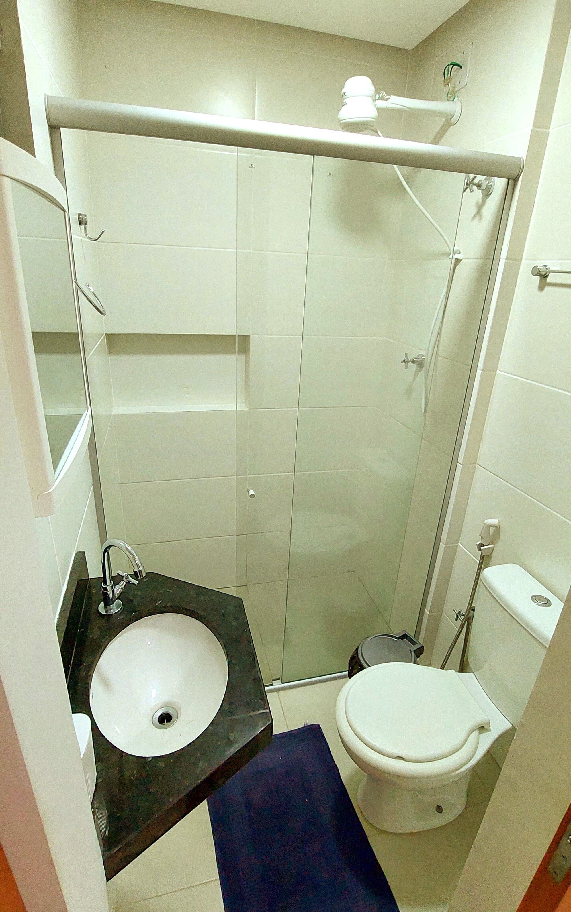 A bathroom with a sink, toilet, and shower.