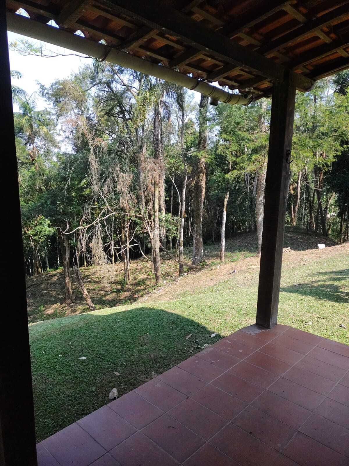 An outdoor patio area with a view of a forested landscape.