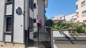 A building with a sign for "Dian's Suites & Restaurants" and a Turkish flag. - Diana's Suites Ephesus (Selçuk)