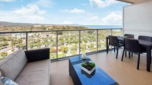 A balcony with a view of a residential area, a dining table with chairs, and a sofa. - 1 bedroom beautiful apartment in Cabanes (Cabanes)