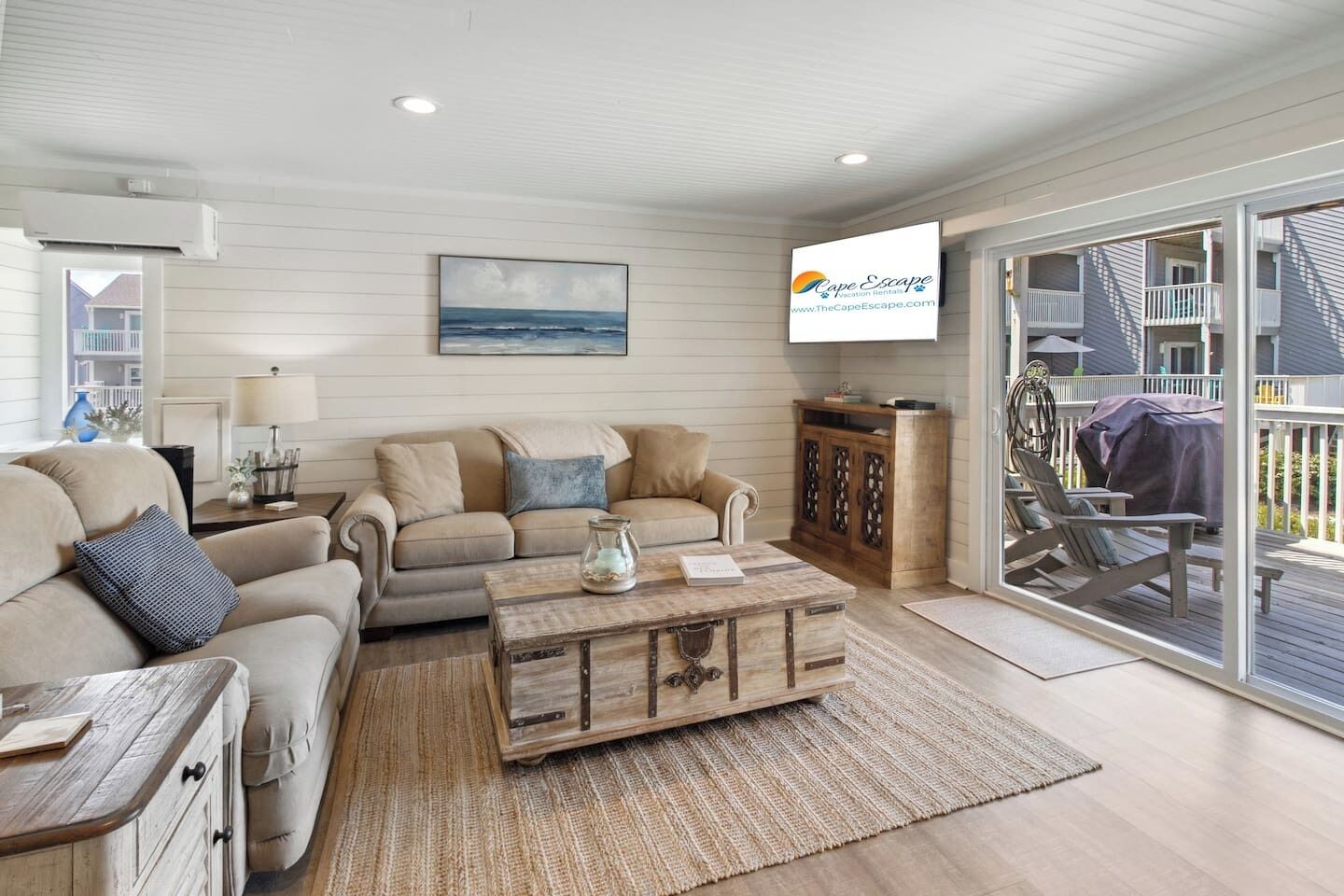 A living room with a sofa, coffee table, and a painting on the wall.