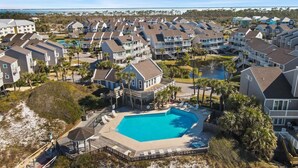 A coastal residential area with a large swimming pool surrounded by houses.