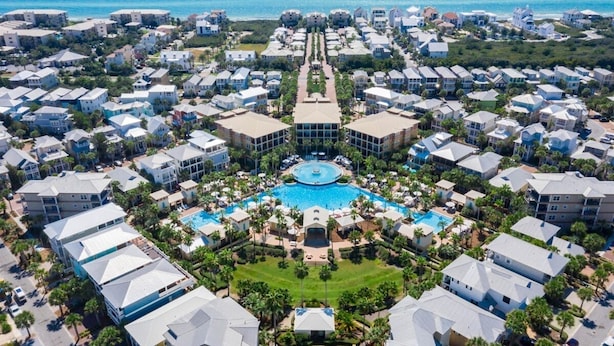 An aerial view of a resort with multiple buildings, a central pool, and a clear view of the ocean. - SEA-REST!! Relaxed 4br 4ba home, POOL and close to the BEACH! (Alys Beach)