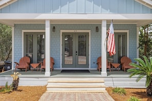 A house with a porch, two doors, and an American flag. - SEA-REST!! Relaxed 4br 4ba home, POOL and close to the BEACH! (Alys Beach)