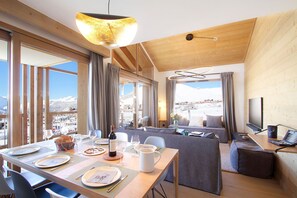 Enjoy a meal for two in the dining area, complete with a table set and a bottle of wine.