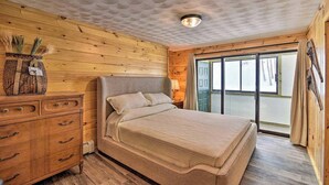 A wooden room with a bed, a dresser, and a window. - Kineo Overlook (Beautiful Mountain Views) (Rockwood)