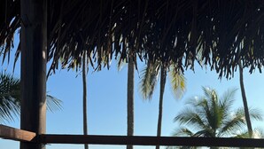 A wooden deck with a bench and a table, overlooking a beach with palm trees and the ocean. - Pacific Ocean-Front Villa de Azul. stunning Sunrises & Sunsets, 3bd 2 full baths (Provincia de Puntarenas)