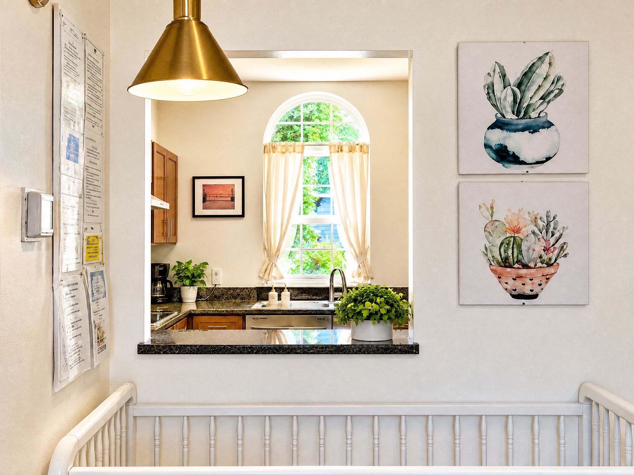 A kitchen with a window, a sink, a countertop, and a hanging light fixture.