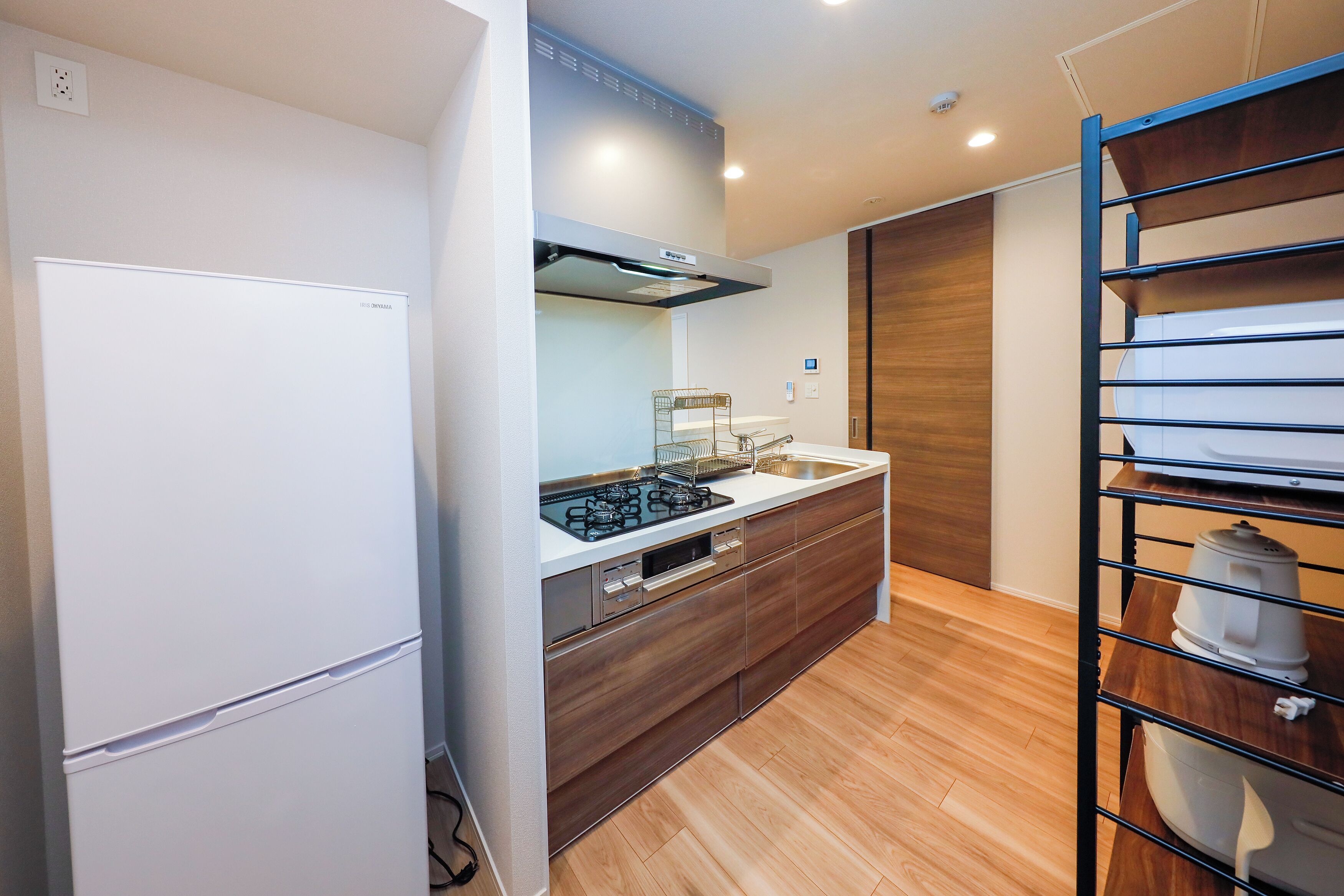 A modern kitchen with a built-in stove, oven, and sink.