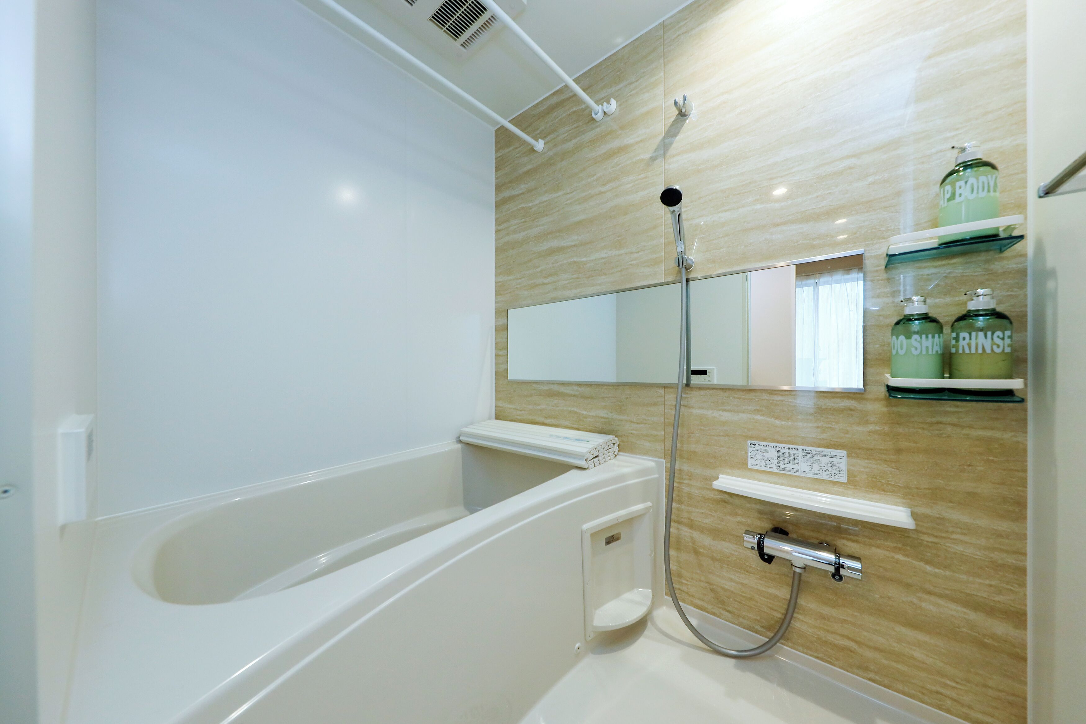 A modern bathroom with a bathtub, a shower, and a vanity with a mirror and shelves.