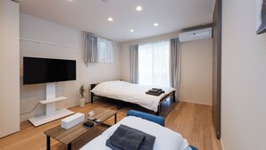 A hotel room with a bed, a TV, a desk, and a chair. - La Terrasse Higashikomagata by Tranova (Tokyo)