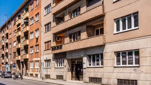 A multi-story building with balconies, a ground-level entrance, and a visible signboard. - Lavanda Apartment With Terrace, Zagreb, Croatia (Zagreb)